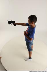 TIMBO STANDING POSE WITH GUN